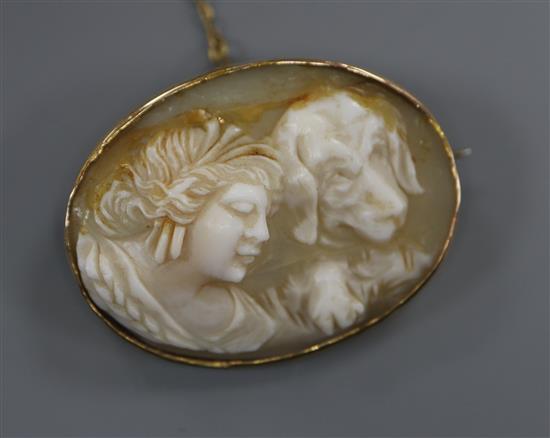 A 9ct mounted oval cameo brooch carved with the head a lady and a hound (a.f.), 34mm.